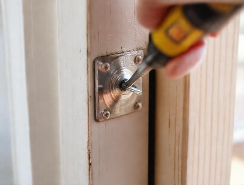 Strike plate alignment checked on a door frame